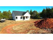 Newly constructed home with a white exterior, dark roof, and covered porch at - Beltline Rd # 10, Chester, SC 29706