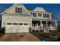 Two-story house with a white garage door and stone accents at 1770 Post Ct # Lot 510, Gastonia, NC 28054