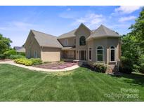Charming home with manicured lawn, lush landscaping, and a welcoming entrance at 122 Long Cove Ln, Mooresville, NC 28117