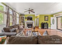 Spacious living room featuring a fireplace, herringbone floors, and lots of natural light at 3951 Springs Rd, Conover, NC 28613