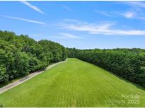 Aerial view of a large lot with expansive green lawn and wooded perimeter, perfect for building a dream home at 6620 Old Concord Rd, Salisbury, NC 28146