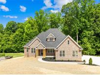 Charming brick home featuring a manicured front yard, black shutters, and a welcoming entrance at 2627 Ashbourne Dr, Gastonia, NC 28056