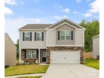 Charming two-story home with stone accents, blue shutters, and a well-manicured front lawn at 4120 Village Nw Blvd, Conover, NC 28613