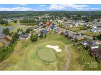 Aerial view of a neighborhood with a golf course, showcasing the property's location and surroundings at 135 Tenth Green Ct, Statesville, NC 28677