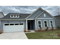 Charming one-story home featuring a two-car garage and welcoming front porch at 5209 Mint Harbor Way # 0352, Charlotte, NC 28269