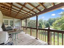 Spacious back porch with wooden deck and wooded views at 7507 Waxhaw Creek Rd, Waxhaw, NC 28173
