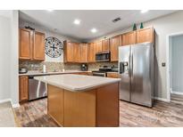 Modern kitchen with stainless steel appliances and an island at 6801 Cinnamon Cir, Mint Hill, NC 28227