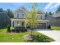 Beautiful two-story home featuring stone accents, a two-car garage, and professionally landscaped front yard at 2024 Cedar Falls Dr # 9, Waxhaw, NC 28173