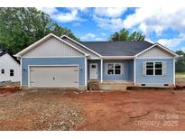 Charming single Gathering home featuring blue siding, a front-facing garage, and a welcoming front porch at 6187 Long Branch Rd, Salisbury, NC 28147
