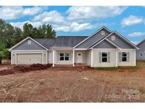 Charming single-story home with light gray siding, attached garage, and manicured lawn ready for its new owner at 6201 Long Branch Rd, Salisbury, NC 28147