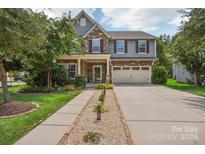 Two-story home with stone accents and a landscaped front yard at 4043 Orchid Way, Tega Cay, SC 29708