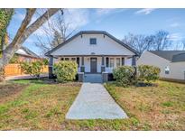 Charming home featuring a welcoming front porch and beautifully landscaped front yard at 1003 Ridge Ave, Kannapolis, NC 28083
