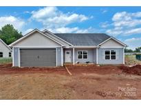 New construction home featuring light gray siding, a two-car garage, and a classic roof design at 6217 Long Branch Rd, Salisbury, NC 28147