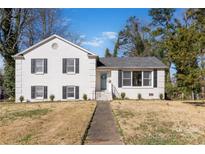 Charming white brick two-story home with black shutters and well-maintained front lawn at 1628 Shannonhouse Dr, Charlotte, NC 28215