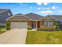 Brick ranch home with 2-car garage, landscaped lawn, and charming front porch at 108 Fleming Dr, Statesville, NC 28677