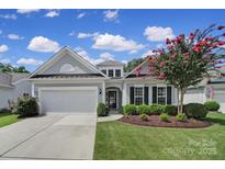 Charming single-Gathering home featuring a well-manicured lawn and attached two-car garage at 2105 Kennedy Dr, Indian Land, SC 29707