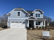 Two-story house with light blue siding, white trim, and a two-car garage at 4684 Hopsack Dr # Cal0105, Indian Trail, NC 28079