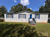 Charming single-story home with blue shutters and a well-maintained lawn at 6261 Burnhurst Ln, Denver, NC 28037