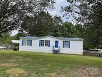 Charming single-story home featuring blue shutters and a spacious front lawn at 6261 Burnhurst Ln, Denver, NC 28037