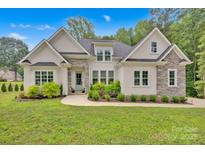 Charming single Gathering home with stone and stucco exterior and well-manicured front lawn at 7245 Static Way, Sherrills Ford, NC 28673