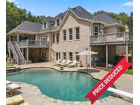 Luxury home with a beautiful pool, expansive patio, and large backyard at 8516 Mcilwaine Rd, Huntersville, NC 28078