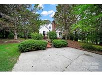 Charming home with a brick chimney, mature trees, and a spacious driveway at 9143 Sadlers Ridge Rd, Fort Mill, SC 29707