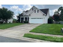 Two-story house with attached garage and well-maintained lawn at 4817 Mossy Cup Ln, Monroe, NC 28110