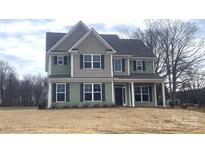 Two-story house with green and gray siding, and a covered front porch at 822 N Rocky River Rd, Monroe, NC 28110