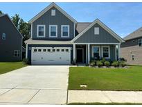 Charming two-story home featuring a well-manicured lawn and a double-door garage at 8165 Annsborough Nw Dr, Concord, NC 28027
