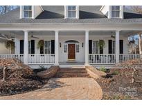 Two story home with a wrap around porch and brick walkway at 170 Old Post Rd, Mooresville, NC 28117