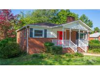 Brick ranch house with a red front door and a white porch at 609 Rowan Mills Rd, Salisbury, NC 28147