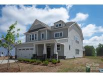 Charming two-story home showcasing meticulous landscaping, stone accents, and a covered front porch at 4808 Glen Stripe Dr # Cal0036, Indian Trail, NC 28079