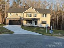 Two-story house with gray siding, black garage doors, and a landscaped yard at 1133 Heather Oak Ln, Oakboro, NC 28129