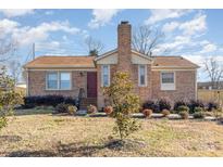 Charming brick home with a well-maintained lawn and mature landscaping at 1007 Ashford St, Charlotte, NC 28214