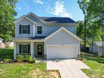 Charming two-story home with attached two-car garage and well-manicured front lawn at 8932 Myra Way, Charlotte, NC 28215