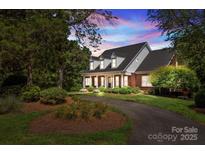 Brick home with landscaped yard and driveway at 721 Orphanage Rd, Concord, NC 28027