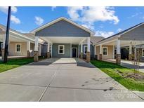 Gray exterior of house with covered carport and brick accents at 1517 28Th Street Se Pl, Hickory, NC 28602