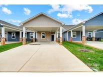 Three-unit townhome development showcasing covered parking and well-manicured lawns at 2866 15Th Avenue Se Pl, Hickory, NC 28602