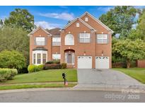 Brick two-story house with a two-car garage and landscaped lawn at 1801 Briarcrest Dr, Charlotte, NC 28269