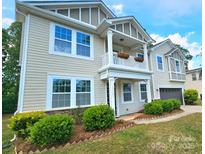 Charming two-story home showcasing a welcoming front porch and manicured landscaping at 11521 Allen A Brown Rd, Charlotte, NC 28269