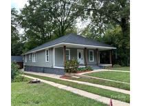 Charming single-story home featuring a covered front porch with wooden columns, a well-manicured lawn, and a concrete driveway at 360 Spring Sw St, Concord, NC 28025