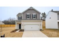 Charming two-story home with a gray and beige exterior, a two-car garage, and a well-maintained front yard at 22 Porter Nw St # Sw22, Concord, NC 28027