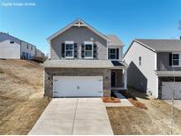 Charming two-story home with brick and shingle accents, two-car garage, and manicured lawn at 22 Sherwood Nw Ct # Sw22, Concord, NC 28027