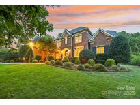 Brick two-story home with landscaped lawn and a large front yard at 7025 Willow Trace Ln, Weddington, NC 28104