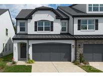 Charming two-story home with a gray two car garage and painted white brick exterior at 4861 Blanchard Way, Charlotte, NC 28226