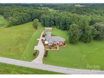 Expansive estate on lush acreage features a brick home, garage and long driveway at 720 Miller Chapel Rd, Salisbury, NC 28147