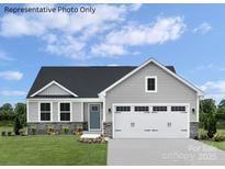 Charming single-Gathering home featuring stone accents, a two-car garage, and a well-manicured lawn at 467 Hollis Dr # 0055, Lancaster, SC 29720