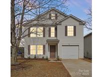 Charming two-story home with a well-maintained lawn and classic architectural details at 4242 Quinn Dr, Charlotte, NC 28269