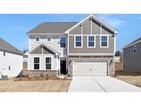 This home features a light gray color, a grey shake accent, and a two-car garage at 121 Saidin Ln, Troutman, NC 28166