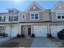 Charming townhome featuring neutral siding, an attached garage, and a well-manicured lawn at 3933 Townes Blvd, Terrell, NC 28682